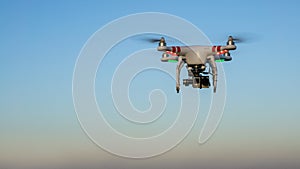 View of drone flying with digital camera and blue sky background