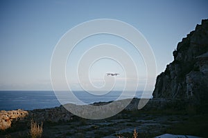 View of a drone flying over the sea at sunset on Siren viewport, in Ceuta