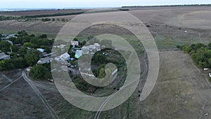 View from drone to the village, dirt roads and cows herd