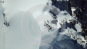 View from the drone top a group of climbers on a snowy peak top. Climbed the peak.