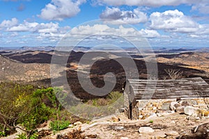 View of dry brazilian valley and abbandoned hut on the top of hill