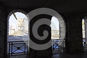 View of the east-side of the Menai Suspension Bridge from undercover stone walkway, North Wales