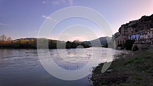 View of the Ebro River and the old town of Miravet, Spain, highlighting the Templar castle in the top of the hill