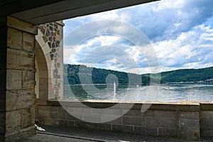 View of the Edersee lake with part of the dam wall, with sailing boat, Germany