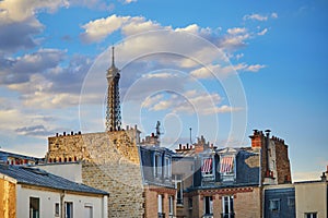 View of the Eiffel tower over the roofs of residential buildings in Paris