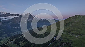 View on the Eiger Nordwand and other famous Swiss Alpine mountains during sunrise on a summer morning