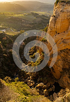 View of the El Tajo Gorge and the Albergue Los Molinos in Ronda in southern Spain at sunset photo