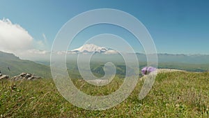 View of Elbrus covered with snow from plateau Bermamyth. Sunny summe afternoon and clouds in the sky