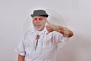 View of an elderly man gesturing with his hand the sign of calling on a white background