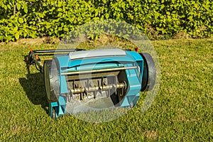 View of electric lawn aerator on green grass isolated.