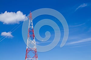 View of electricity pylon against a clear blue sky.