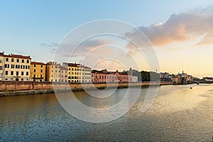 View on embankment of Arno river at sunset. Pisa, Italy