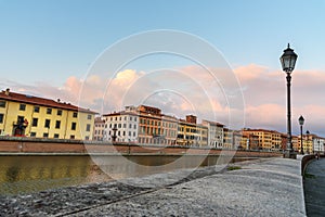 View on embankment of Arno river at sunset. Pisa, Italy