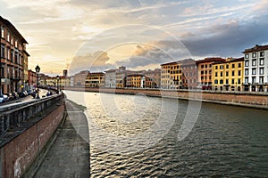View on embankment of Arno river at sunset. Pisa, Italy