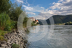 View of the embankment of the river Danube and the medieval monastery Duernstein. Town of Duernstein, Austria.