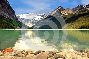 View of the emerald green lake and snow-capped mountains