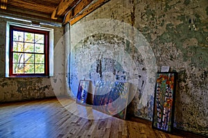 View of an empty art studio with painting on the floor