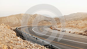 View of empty asphalt road curve in Israel desert. 4K. Roadway in ancient Negev Desert scenery. Modern transportation.