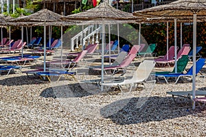 View of empty beach -  colorful sun beds and umbrellas