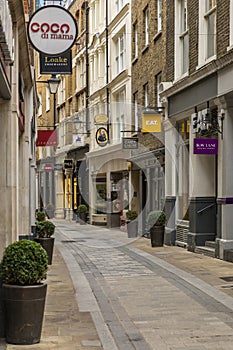 View of empty Bow Lane with restaurants and stores, part of richly historic Bow Lane Conservation Area in London England