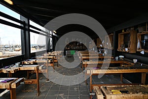 View of empty carpentry workshop classroom, workbenches, tools