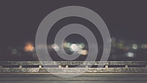 View from empty concrete bridge above the town at night