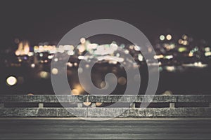 View from empty concrete bridge above the town at night