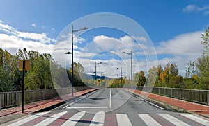 View of empty crosswalk on paved road.