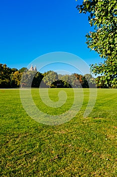 View of empty Great Lawn of Central Park under clear blue sky, in New York City, USA