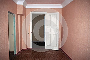 View of an empty hallway with an open door