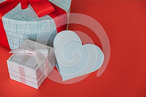 View of an empty heart made of paper next to gift boxes of different sizes