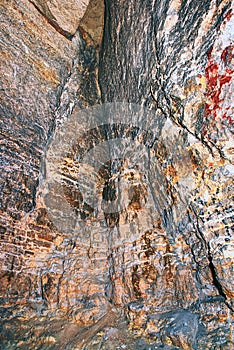 View into an empty medieval catacomb. Tunnel excavated in orange sandstone rock