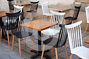 View of empty outdoor terrace cafe outdoor with retro wooden chairs and table in sunny summer day