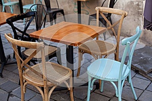View of empty outdoor terrace cafe outdoor with retro wooden chairs and table in sunny summer day