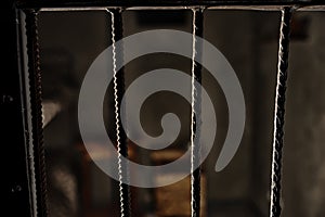 View of the empty prison cell through the bars