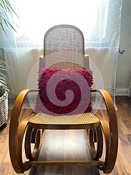 View on empty rocking chair in living room with shadow from backlight of window - grieve and loss of loved person concept