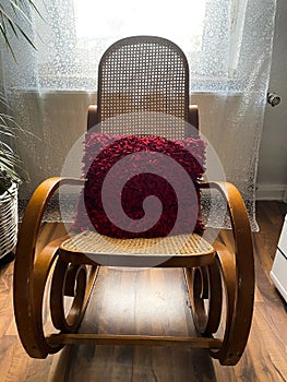 View on empty rocking chair in living room with shadow from backlight of window - grieve and loss of loved person concept