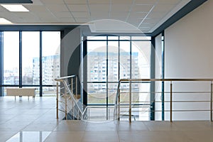 View of the empty spacious hall with large panoramic windows. Modern interior design of an empty office. A room with large windows