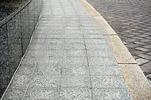 View on empty stone sidewal. Footpath covering