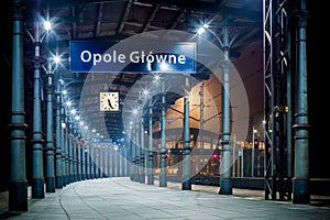 View of an empty train station platform with a clock in Opole Glowne in Poland