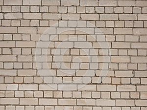 View of empty, white brick wall background with copy space. A deteriorating brick wall outdoors