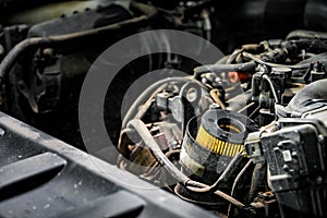 View of engine and other parts under the open hood of a car