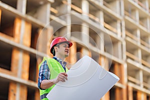 Portrait of an Engineer checking plan on construction site