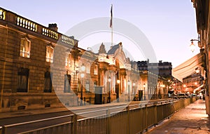 View of entrance gate of the Elysee Palace from the Rue du Faubourg Saint-Honore at night . Elysee Palace - official