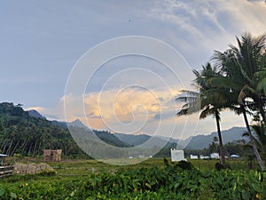 view of the evening sky and mountains in the rice fields