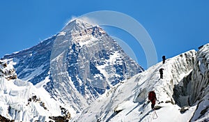 View of Everest from Gokyo valley with group of climbers photo
