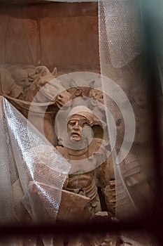 View of expressive sculpture with men and horse, in stone photo