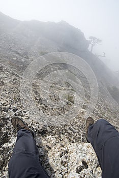 The view from the eyes of the man sitting on top of a mountain