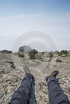 The view from the eyes of the man sitting on top of a mountain