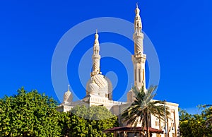 View of the facade of the building of the mosque Jumeirah, Dubai, United Arab Emirates.  on blue background